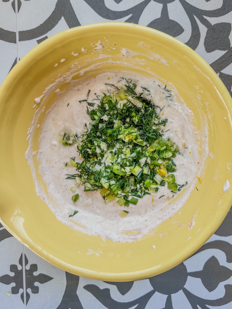 Chip dip being made in a large bowl to serve at a party
