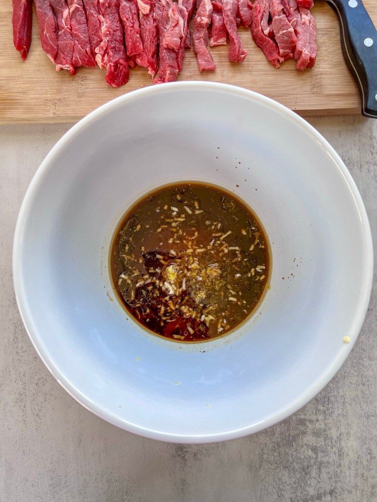 Steak marinade in a bowl before the steak gets tossed in