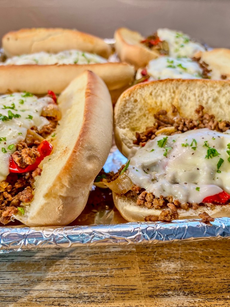 Crockpot Philly cheesesteak sandwiches with fresh parsley on top