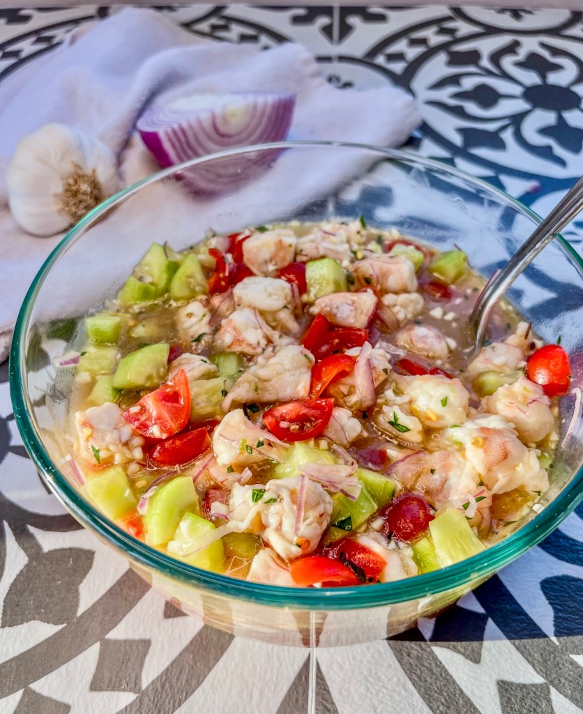 Cucumber shrimp ceviche in a serving dish with a spoon inside
