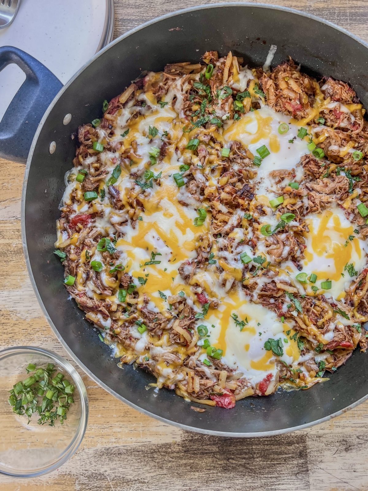 Pulled pork breakfast skillet with green onion and cilantro for garnish