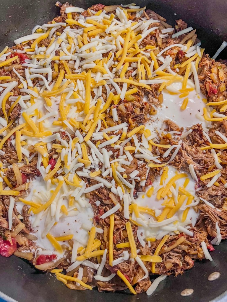 Pulled pork breakfast skillet with some freshly sprinkled cheese on top