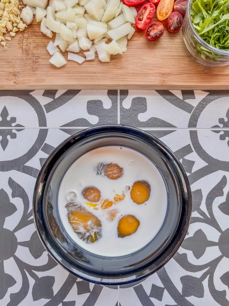 Eggs, half and half, and some salt in a mixing bowl just before whisking