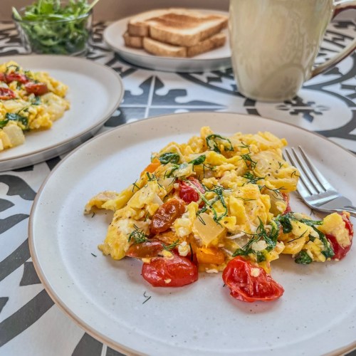 A quick weekday breakfast featuring fresh scrambled eggs and veggies