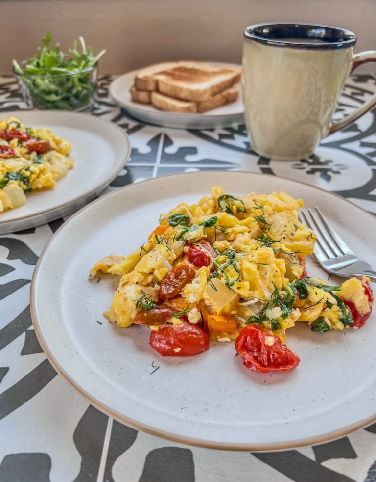 A quick weekday breakfast featuring fresh scrambled eggs and veggies