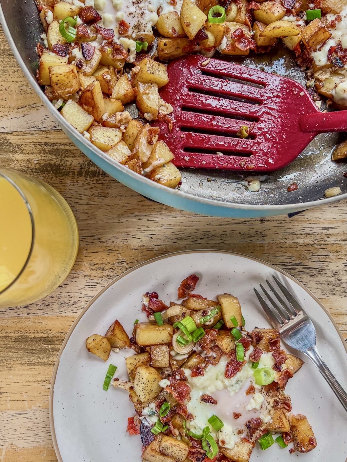 Bacon veggie breakfast hash with gorgonzola cheese, crispy bacon, and green onion on top