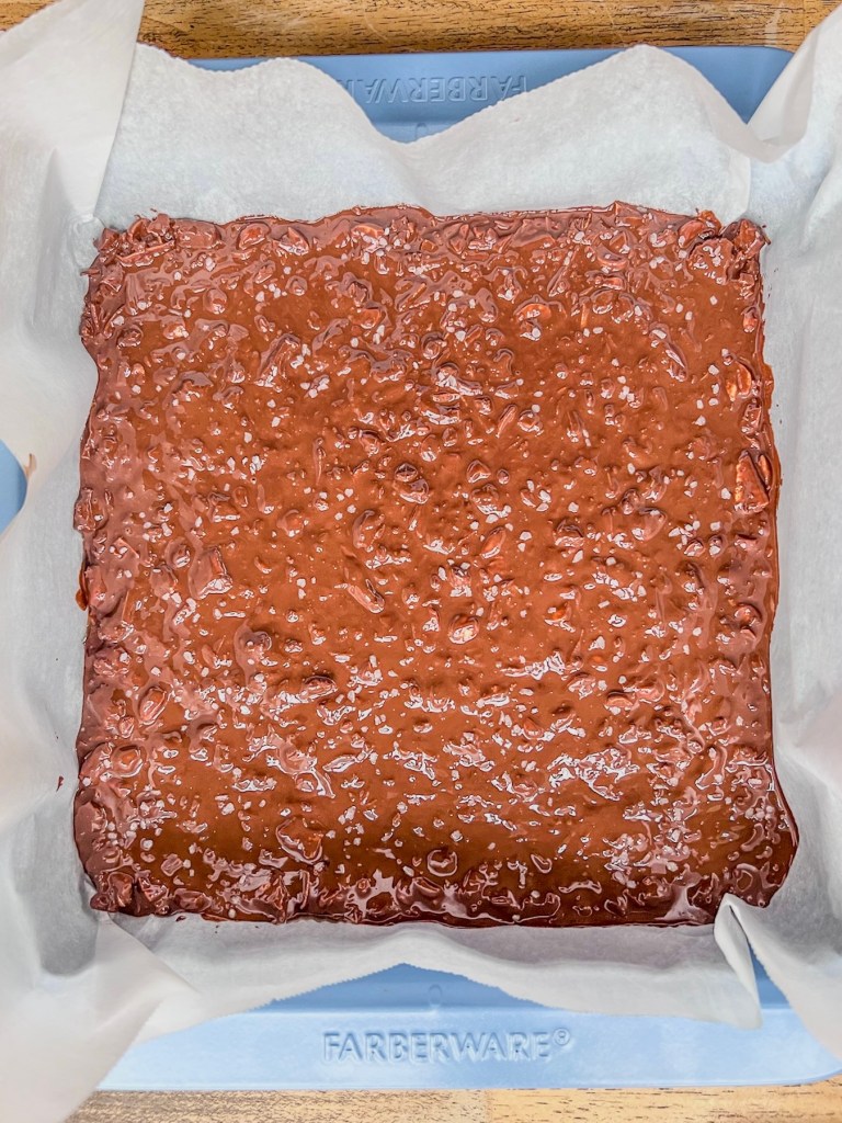 A peanut and chocolate mixture spread into a pan, ready to be chilled.