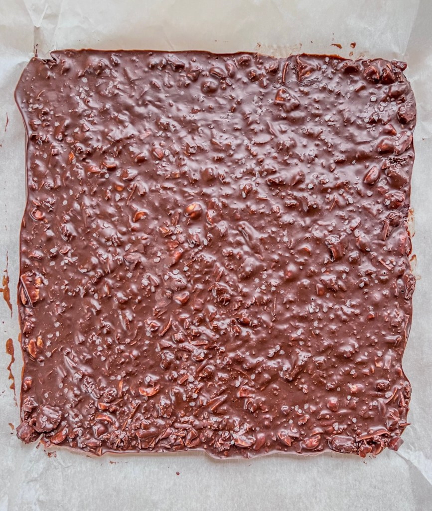 Homemade chocolate crunch bars fresh out of the fridge and ready to be cut.