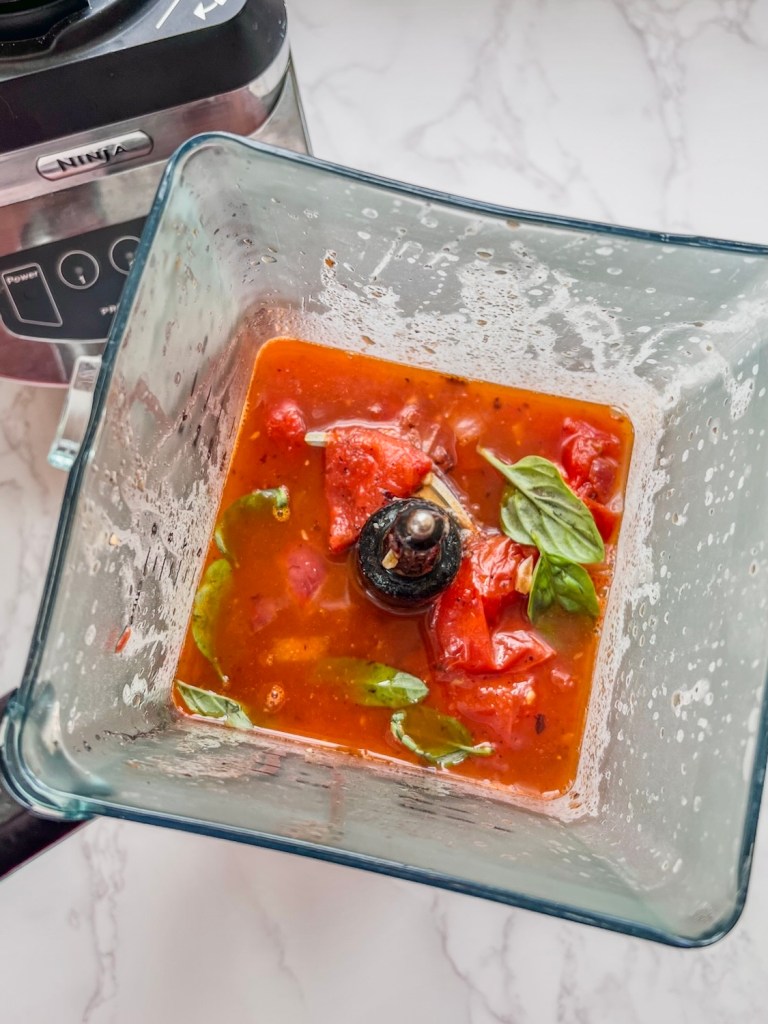 Tomato basil soup in a large blender just before blending