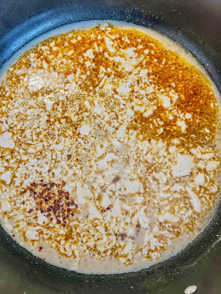 A coconut ginger sauce being built in a skillet on the stove