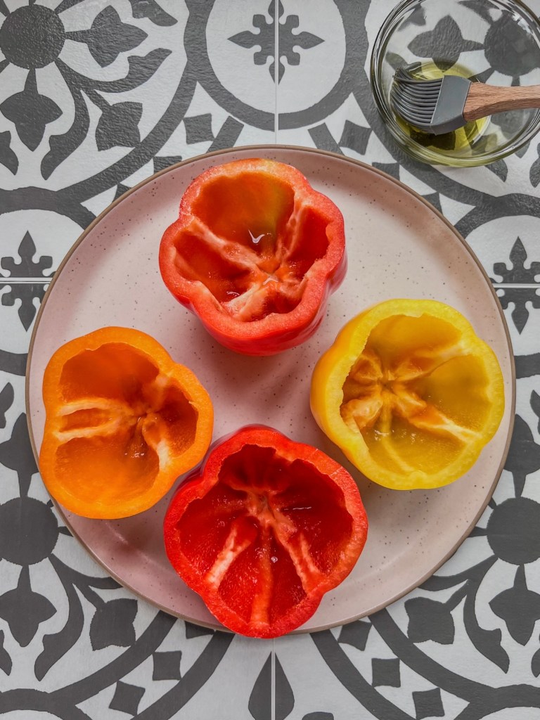 Whole bell peppers that have been deseeded and brushed with oil