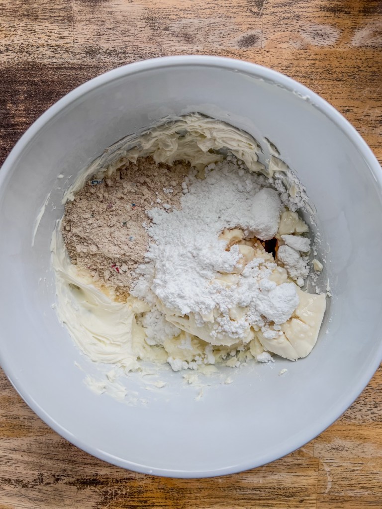 Cream cheese, ricotta cheese, powdered sugar, almond extract, vanilla extract, and Funfetti cake mix in a large mixing bowl.