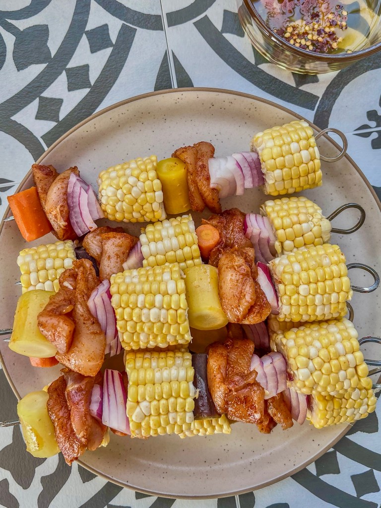 Kabobs with chicken, corn, onion, and carrots just before going on the grill.