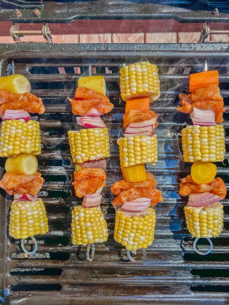 Hot honey grilled chicken skewers just added to the grill.