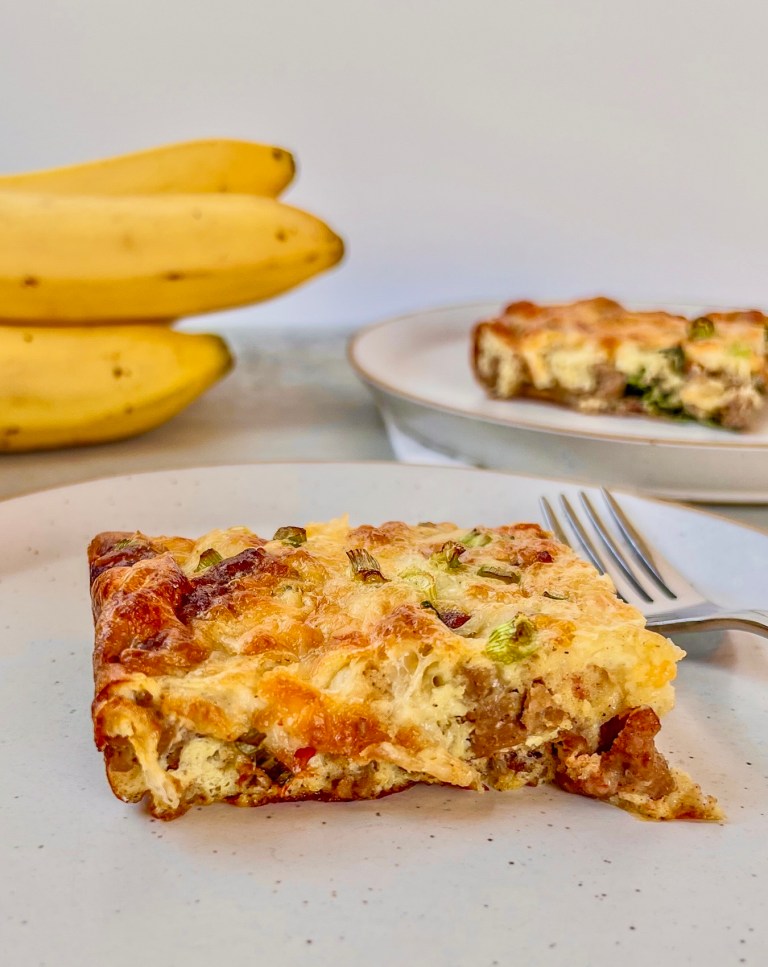 Maple sausage egg bake fresh out of the oven, served with coffee and fresh fruit.