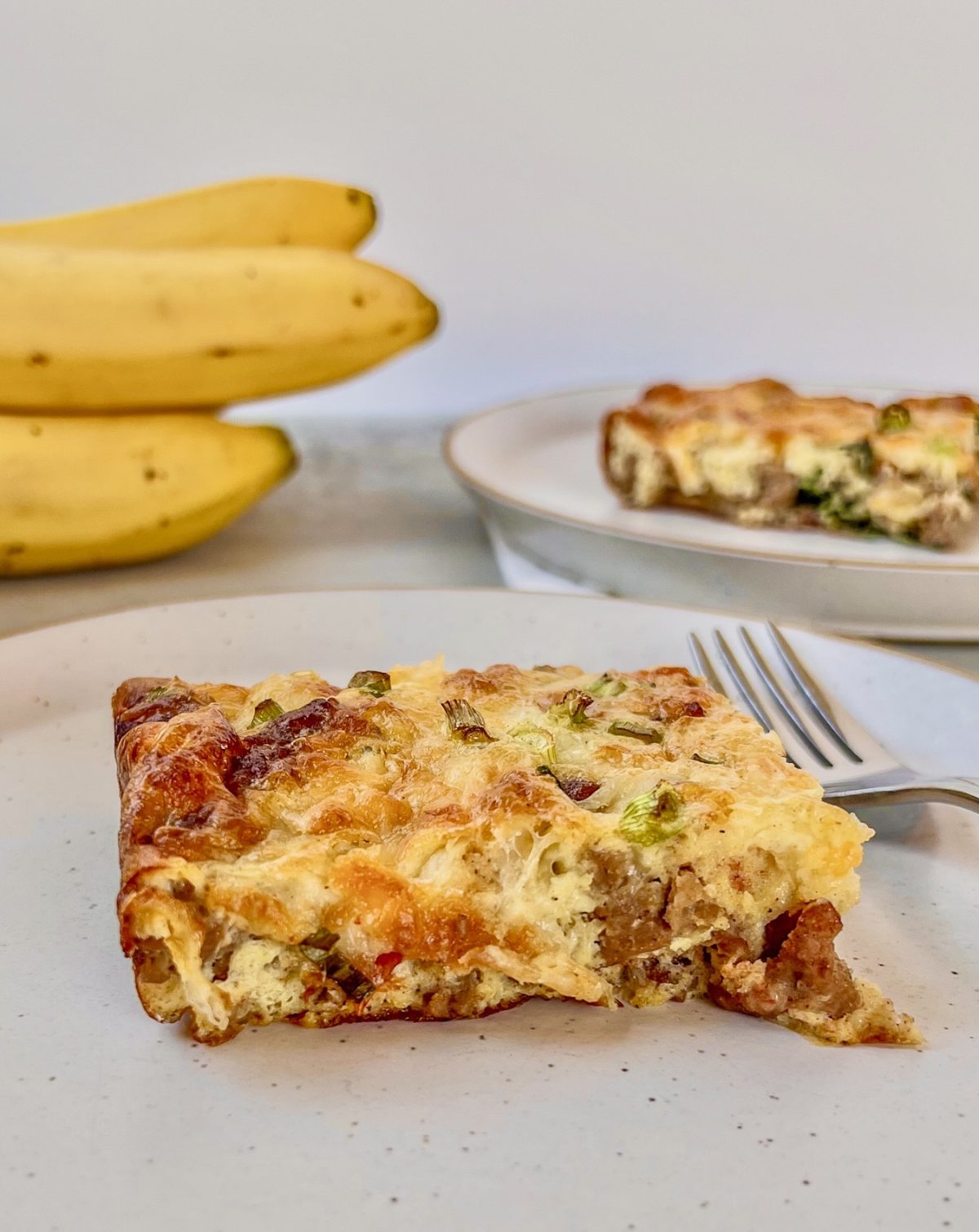 Maple sausage egg bake fresh out of the oven, served with coffee and fresh fruit.