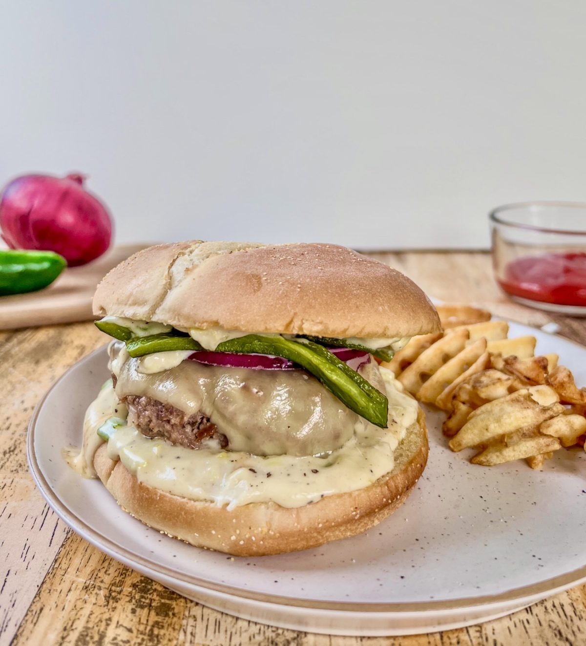 White cheddar and onion jalapeño burgers served with fries on the side.