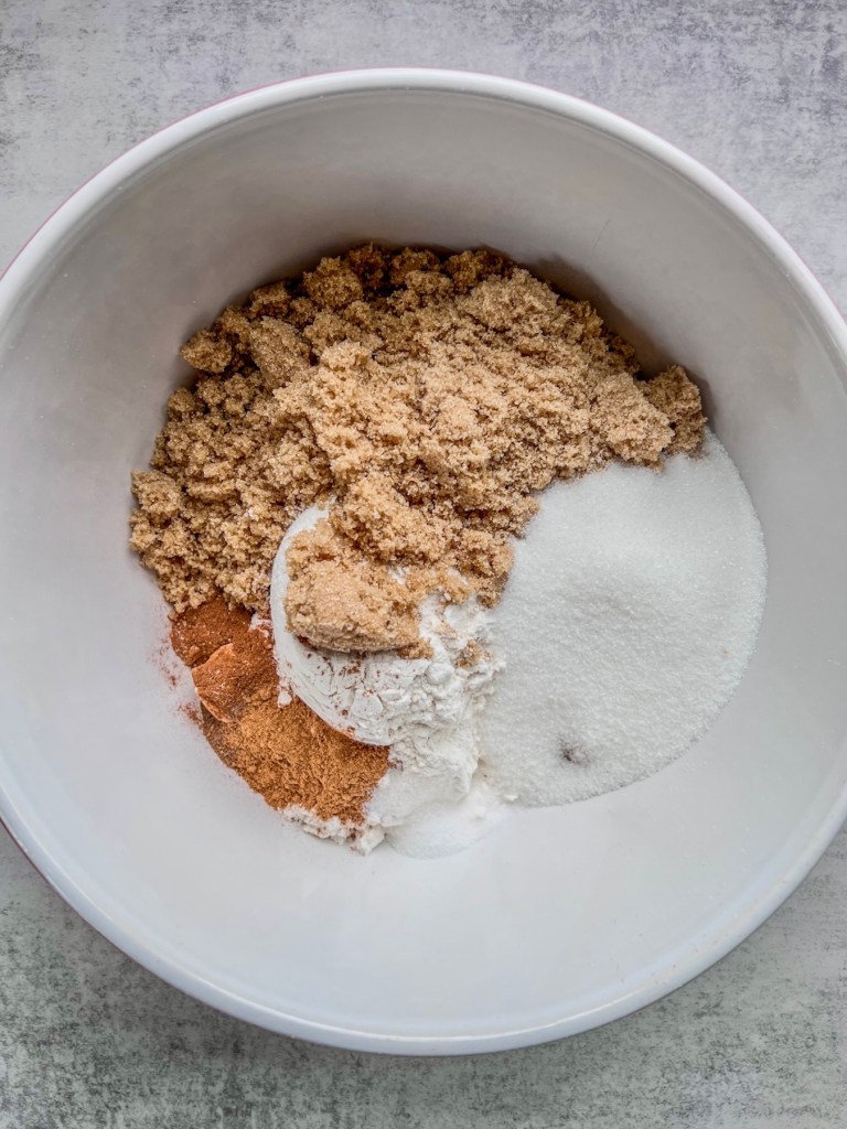 Flour, baking soda and powder, brown and granulated sugar, salt, and spices in a large bowl.