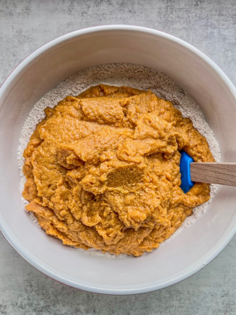 Brown butter pumpkin crumb cake batter coming together in a large mixing bowl.