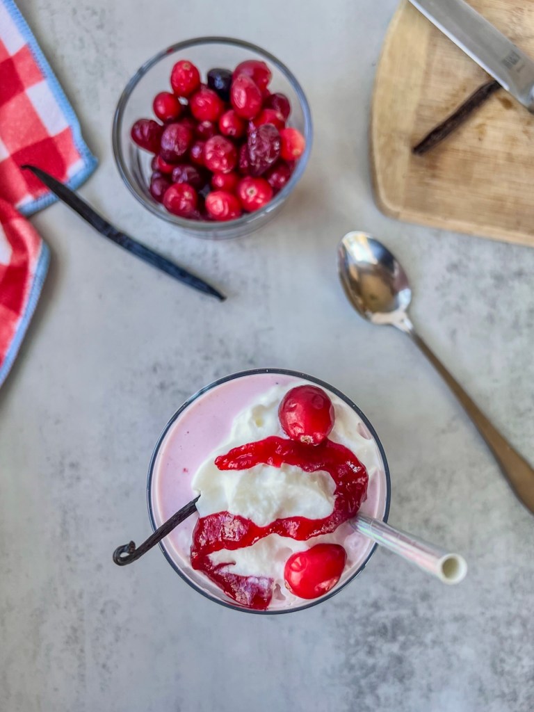 A festive drink featuring vanilla bean ice cream and fresh cranberries.