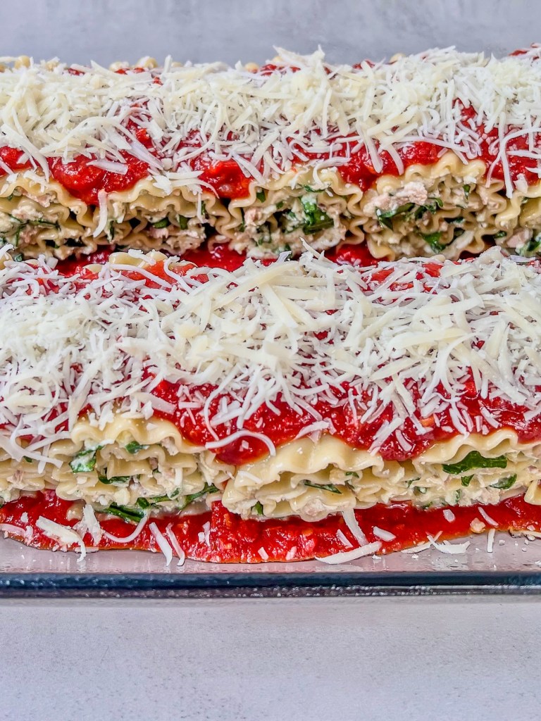 Lasagna roll ups in a baking pan, just before going into the oven.